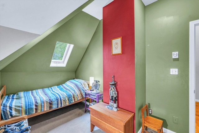 bedroom with a skylight, lofted ceiling, and baseboards
