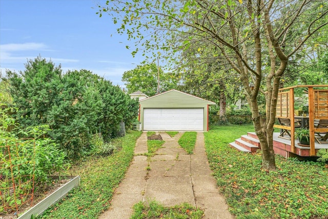 view of yard with a garage, an outdoor structure, and a wooden deck