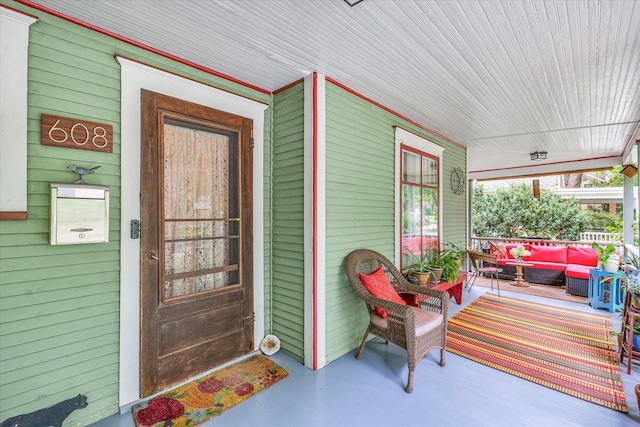property entrance featuring covered porch and an outdoor hangout area