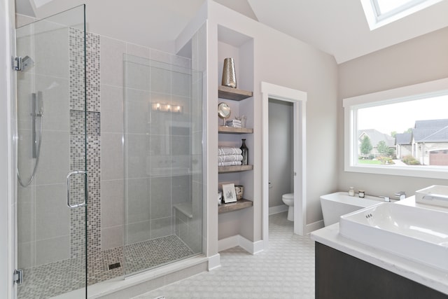 bathroom with dual vanity, toilet, an enclosed shower, a skylight, and tile patterned floors