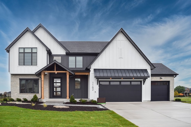 modern inspired farmhouse featuring a front lawn and a garage