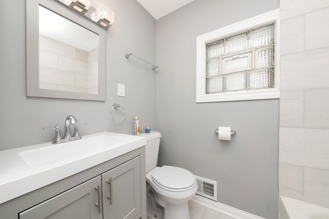 bathroom with tile patterned floors, vanity, a bath, and toilet