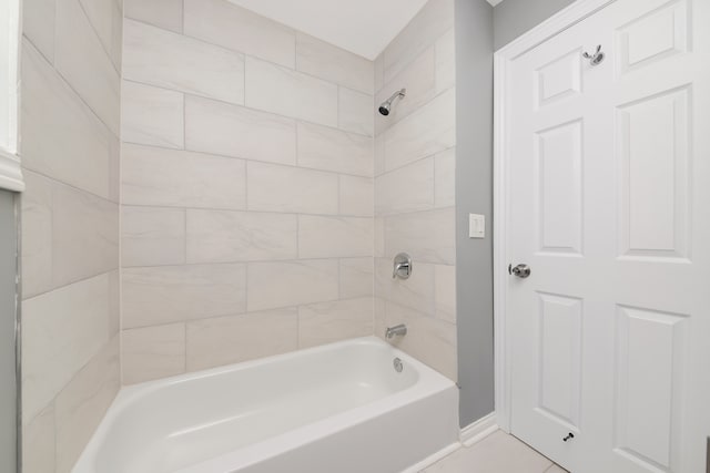 bathroom featuring tile patterned flooring and tiled shower / bath