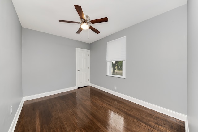 spare room featuring ceiling fan and dark hardwood / wood-style floors