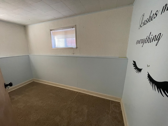 spare room featuring dark colored carpet