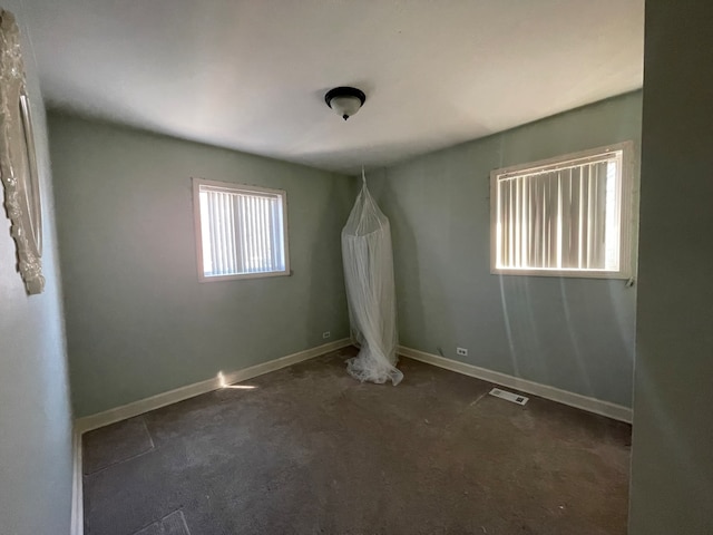 carpeted empty room with plenty of natural light