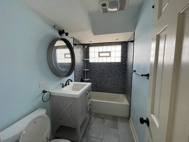 full bathroom featuring tiled shower / bath combo, tile flooring, vanity with extensive cabinet space, and toilet