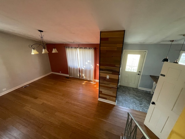 interior space with an inviting chandelier and dark wood-type flooring