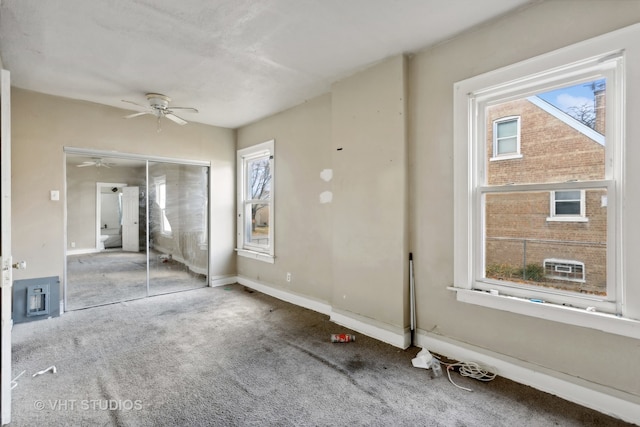 unfurnished bedroom featuring ceiling fan, a closet, and multiple windows