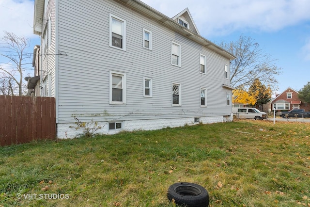 view of property exterior with a lawn