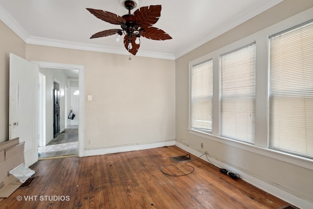 empty room with ceiling fan, hardwood / wood-style flooring, and crown molding