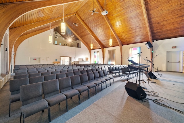 carpeted cinema room with wood ceiling, high vaulted ceiling, ceiling fan, and beam ceiling