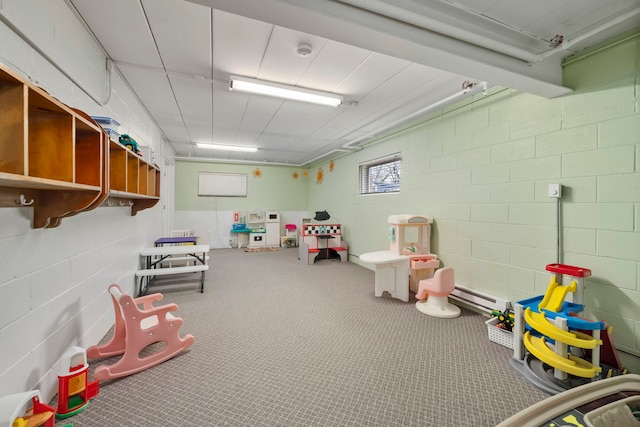 recreation room featuring baseboard heating