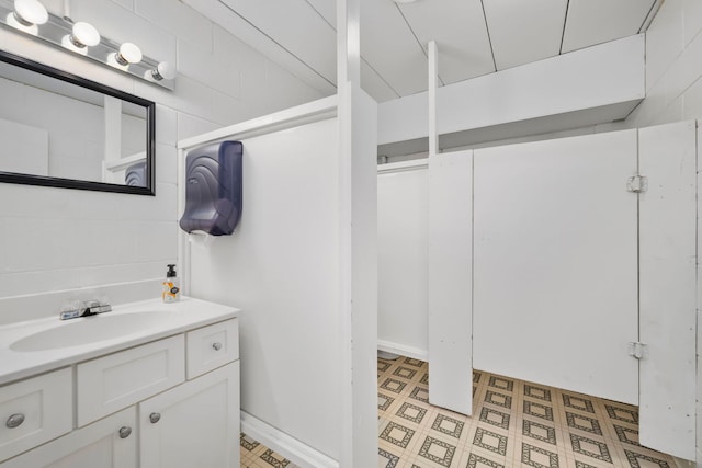 bathroom featuring vanity with extensive cabinet space and tile flooring