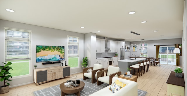 living room with light hardwood / wood-style flooring and sink