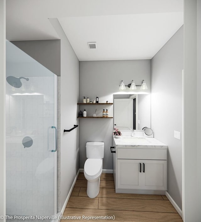 bathroom featuring vanity, a shower with shower door, and toilet