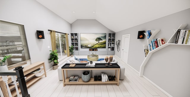 living room with lofted ceiling, hardwood / wood-style flooring, and a healthy amount of sunlight