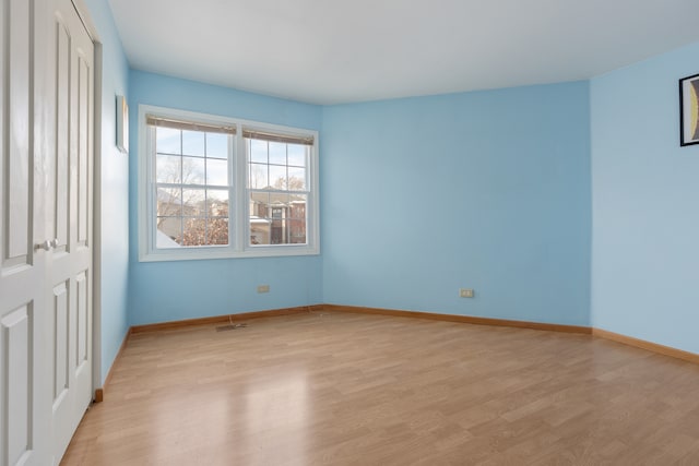 spare room featuring light wood-type flooring