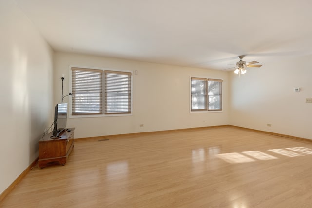 spare room featuring ceiling fan and light hardwood / wood-style floors