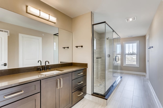 bathroom featuring walk in shower, vanity, and tile flooring