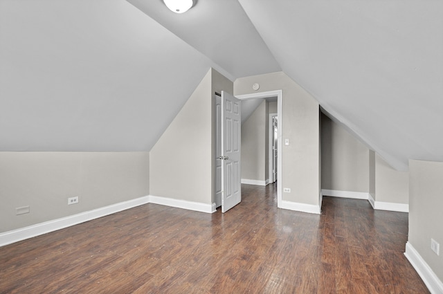 bonus room with lofted ceiling and dark wood-type flooring