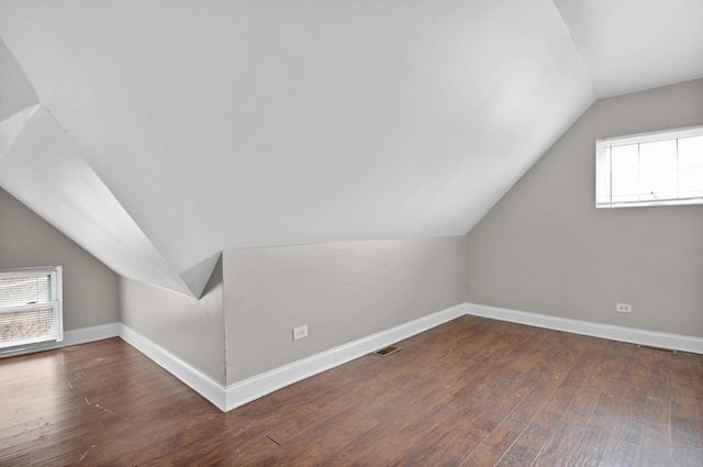 additional living space featuring vaulted ceiling and hardwood / wood-style floors