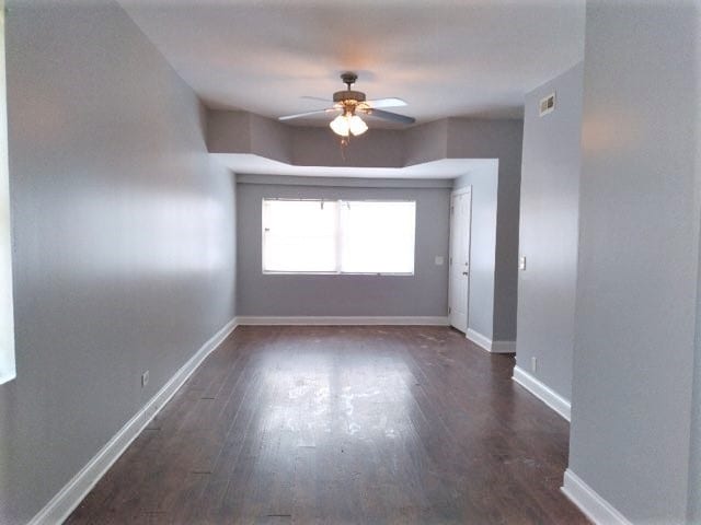 empty room featuring ceiling fan and wood-type flooring