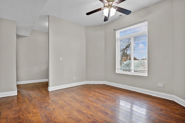 unfurnished room with dark hardwood / wood-style floors, plenty of natural light, and ceiling fan