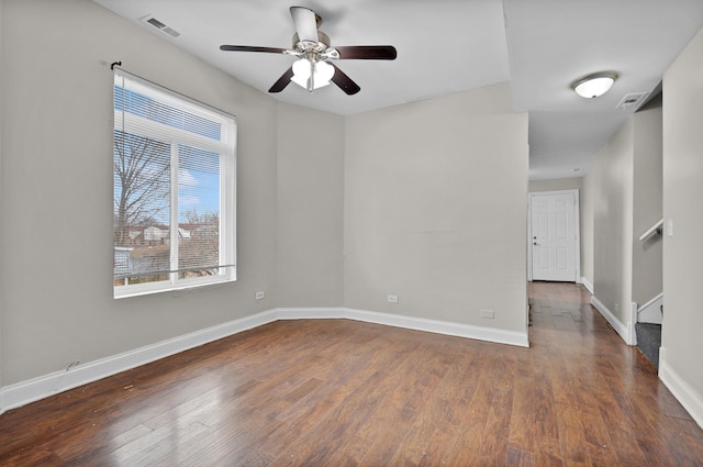 unfurnished room with dark hardwood / wood-style flooring and ceiling fan