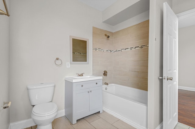 full bathroom with tile floors, vanity, toilet, and tiled shower / bath combo