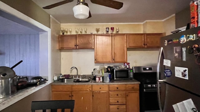 kitchen featuring ceiling fan, sink, and appliances with stainless steel finishes