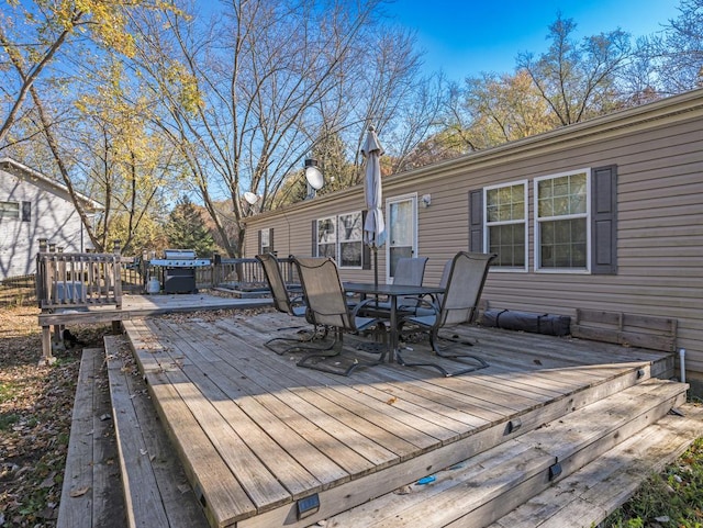 wooden terrace with a grill