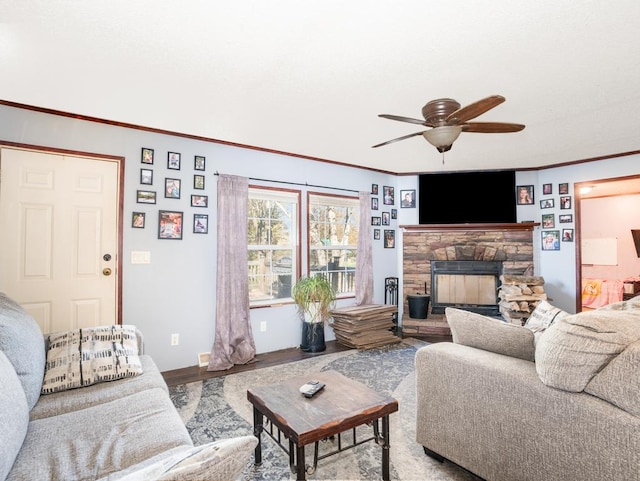 living room with a fireplace, hardwood / wood-style flooring, and ceiling fan