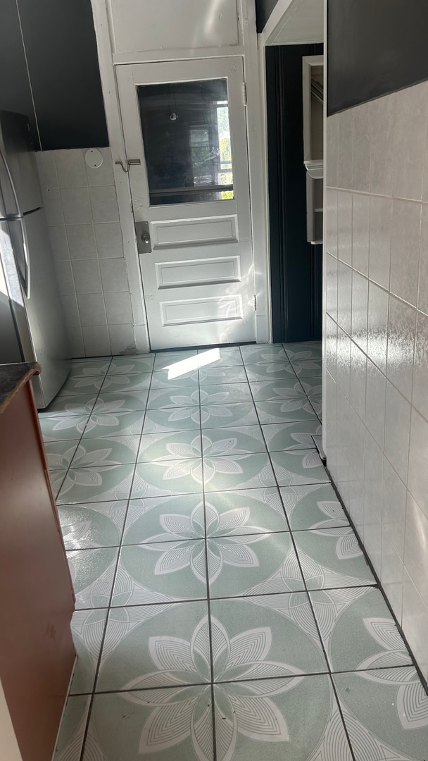 hall featuring tile walls