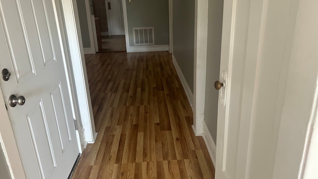 corridor featuring dark wood-type flooring