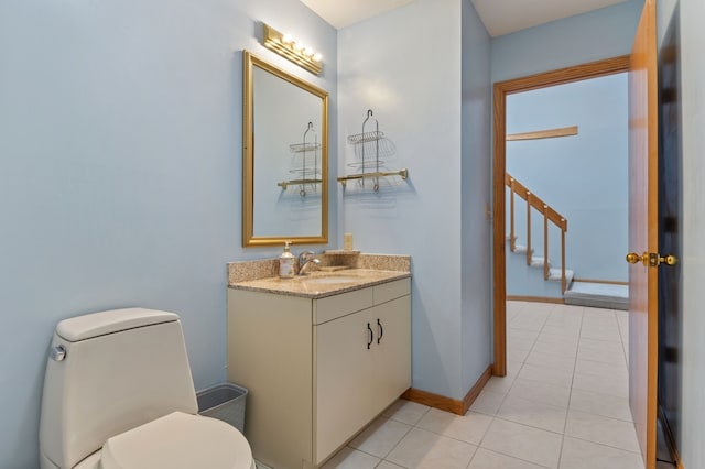 bathroom with tile patterned flooring, vanity, and toilet