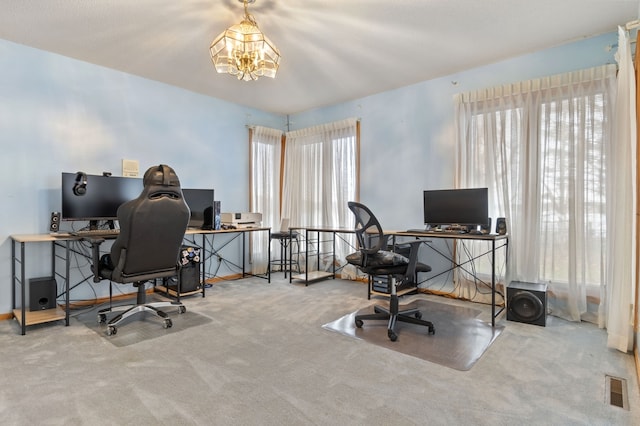 office area with a chandelier and carpet