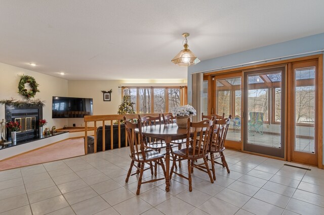 1210 Lakeridge Ct, Danville, IL 61832 - dining area featuring a glass covered fireplace and light tile patterned flooring