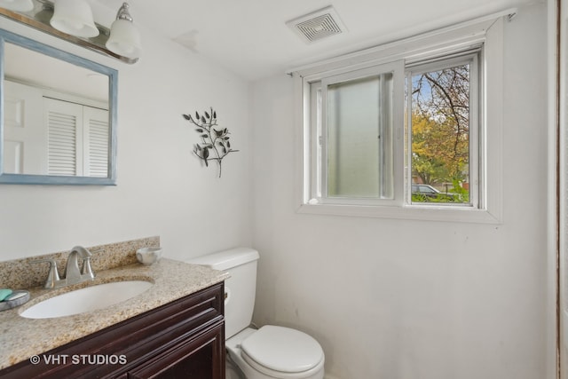 bathroom featuring toilet and vanity