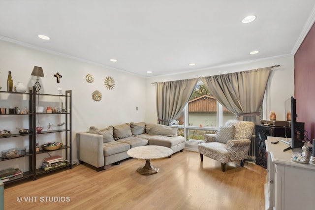 living room featuring ornamental molding and light hardwood / wood-style floors