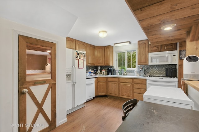 kitchen featuring tasteful backsplash, white appliances, and light hardwood / wood-style floors