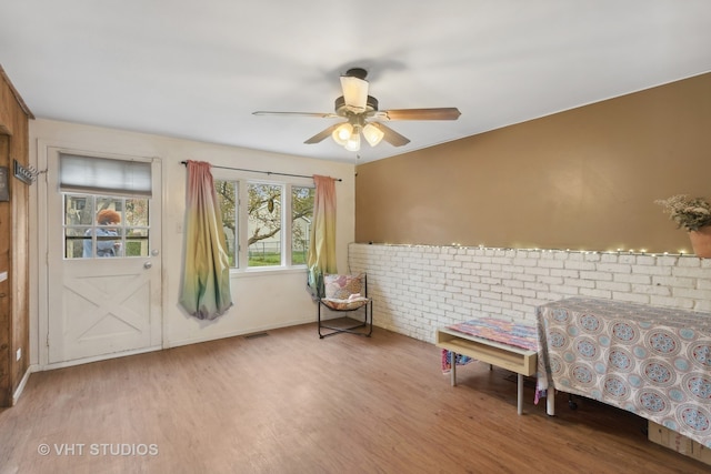 bedroom with ceiling fan and hardwood / wood-style flooring