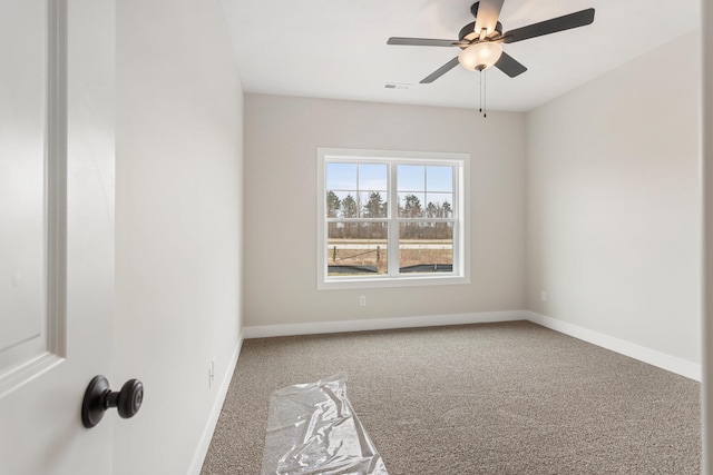 spare room featuring carpet and ceiling fan