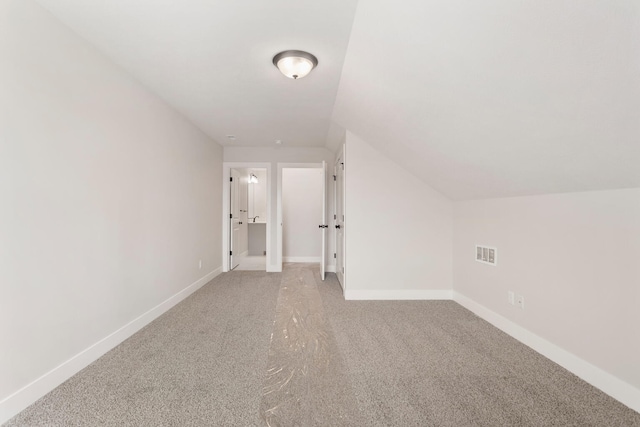 bonus room featuring vaulted ceiling and carpet floors