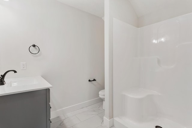 bathroom featuring walk in shower, tile floors, vanity, vaulted ceiling, and toilet