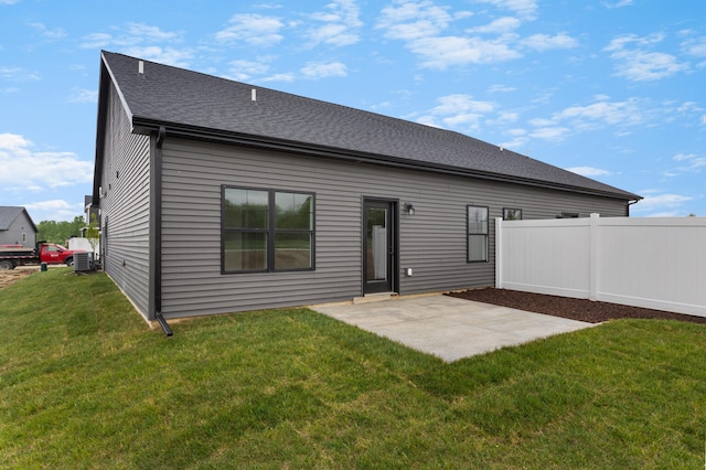 rear view of house featuring a patio, a yard, and central air condition unit