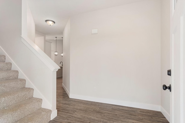 stairs featuring dark wood-type flooring