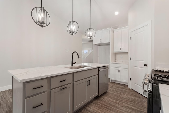 kitchen with hanging light fixtures, dark wood-type flooring, sink, stainless steel dishwasher, and an island with sink