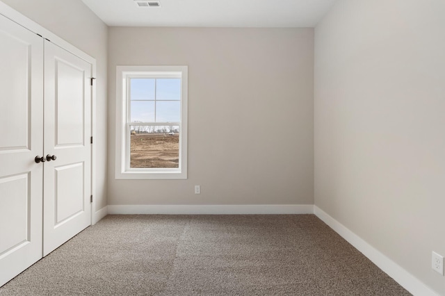 unfurnished bedroom with a closet and carpet floors