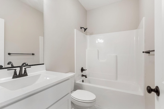 full bathroom featuring washtub / shower combination, vanity, and toilet